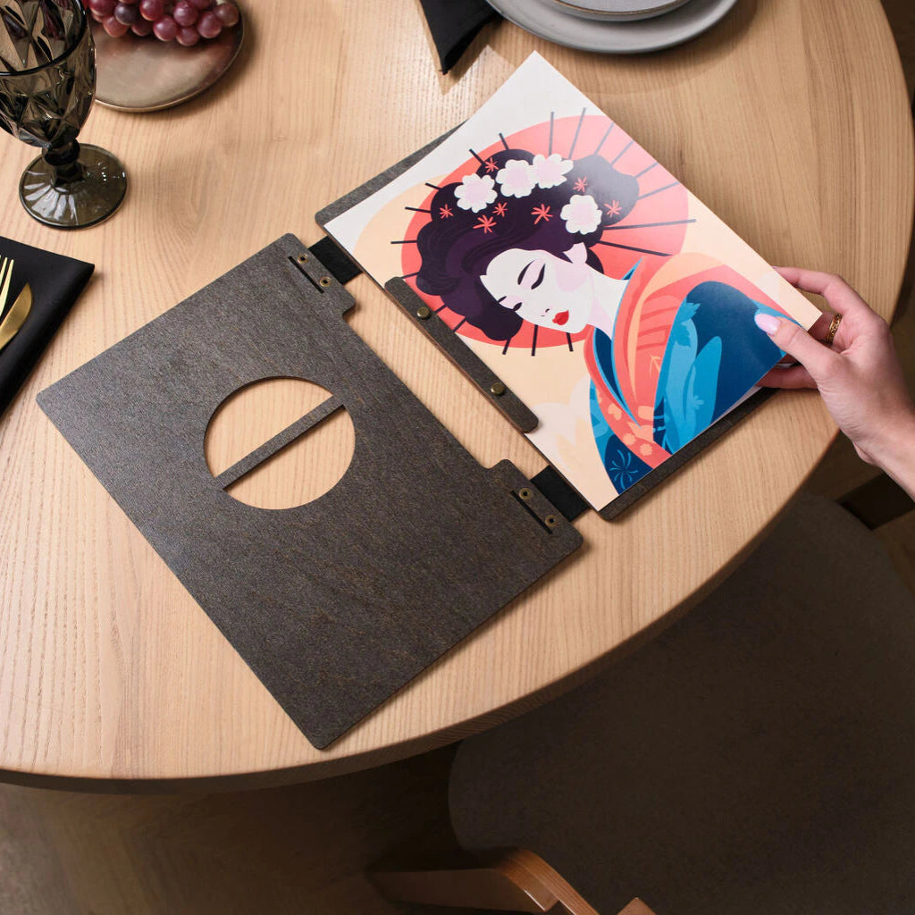 The front cover features a circular cutout with a central horizontal wooden bar