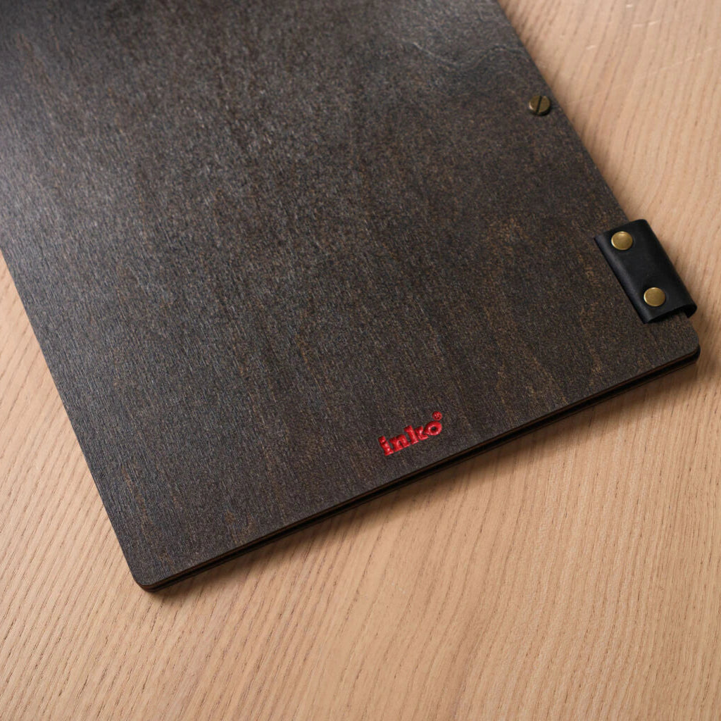 A macro shot of the dark wood texture secured with two slotted brass screws.