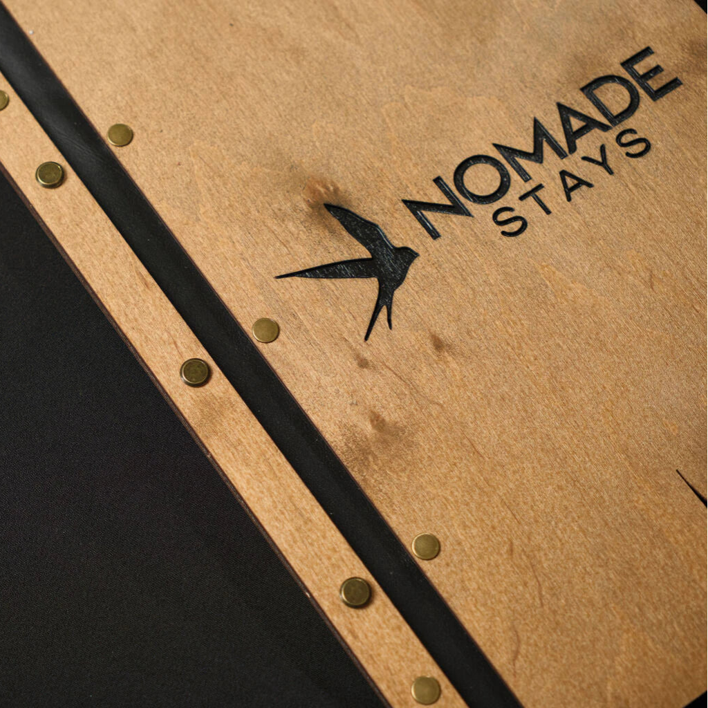 Macro photo of a bird logo engraving on an oak wooden surface, highlighting the depth of laser processing and premium hardware