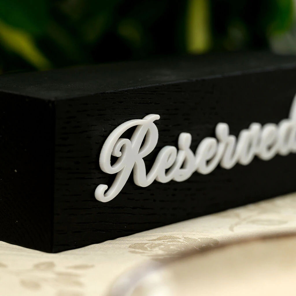 Premium black wooden reservation sign with stylish white cursive text. The contrast between the textured black oak and the smooth white acrylic lettering creates a sophisticated, modern look for cafe and restaurant table settings