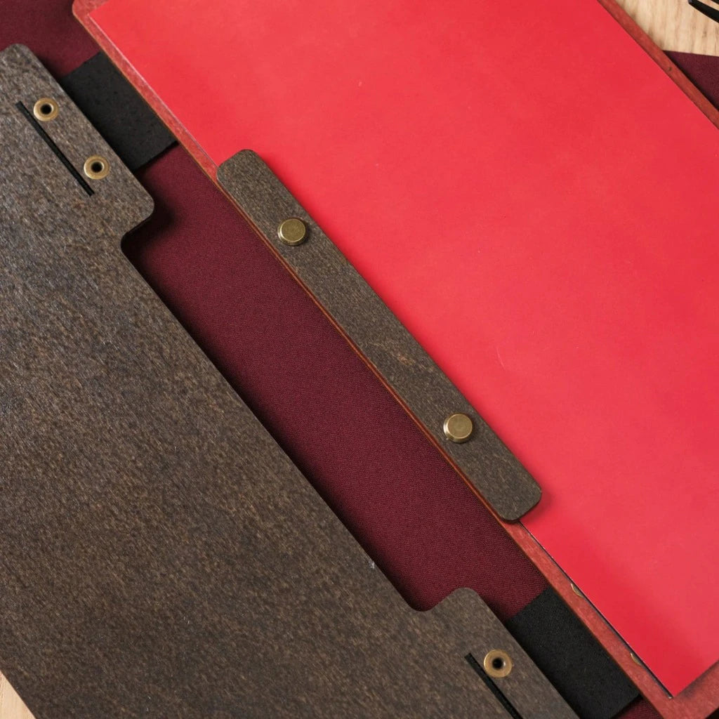 Detailed view of the interior and binding of a premium wooden menu holder with red accents and high-quality metal fasteners